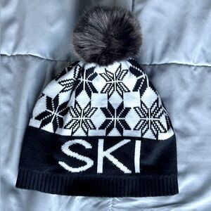 Aspen old logo patch hat Alp n rock says SKI on it with a fur pom